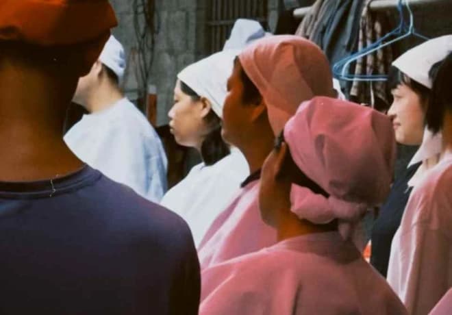 People gathered together, several wearing head coverings.