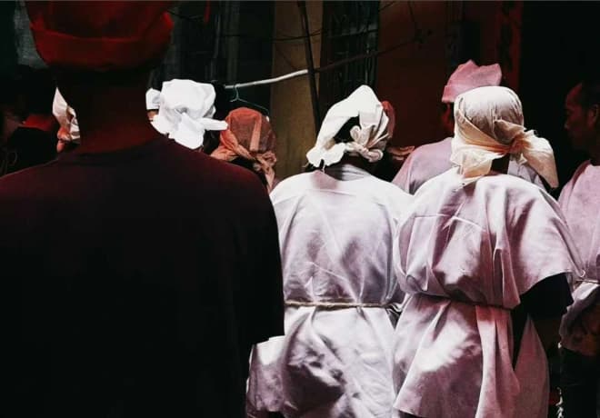 A group of people viewed from behind.