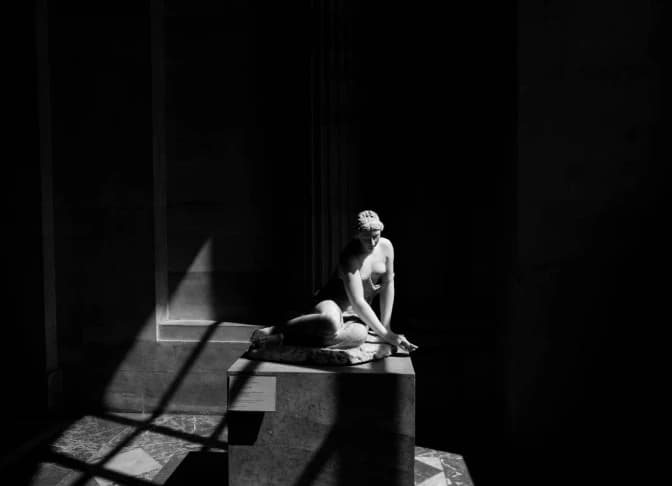 A statue illuminated against darkness.